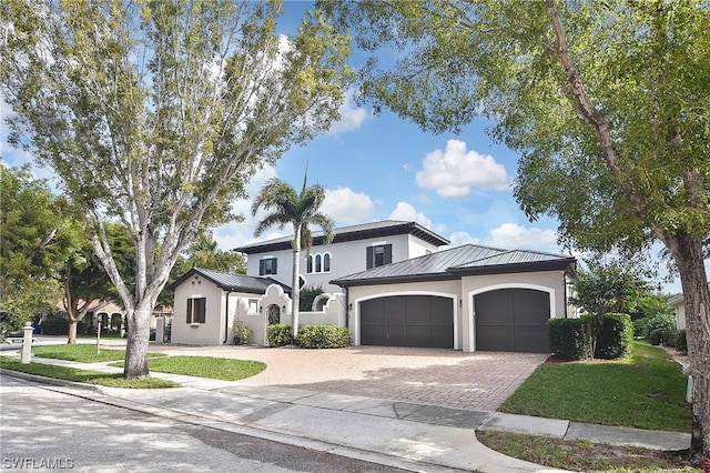 view of front of property with a front yard and a garage