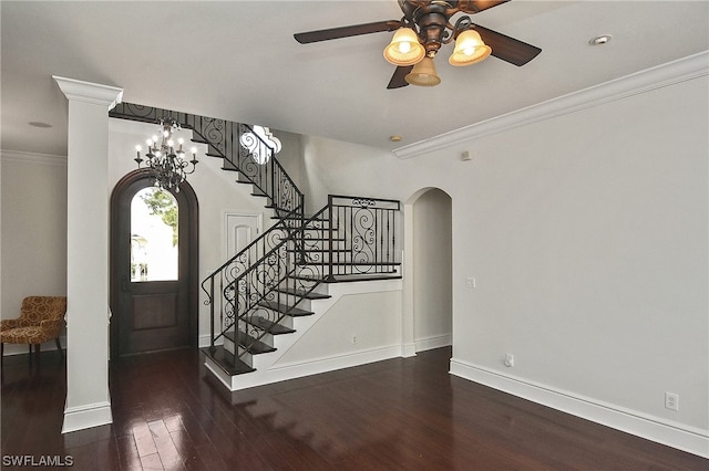 foyer entrance featuring dark hardwood / wood-style floors, crown molding, and ceiling fan with notable chandelier