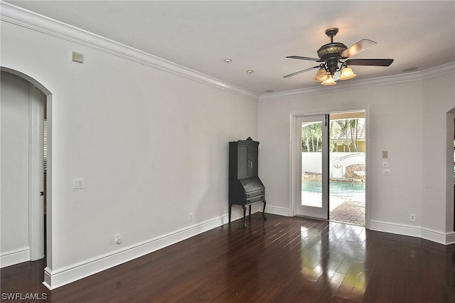 interior space with ceiling fan, dark hardwood / wood-style floors, and ornamental molding