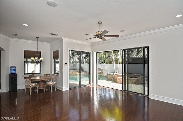 interior space featuring dark hardwood / wood-style flooring, ceiling fan with notable chandelier, and ornamental molding