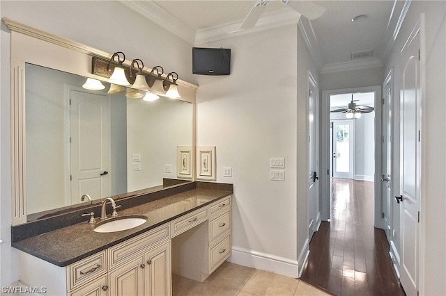 bathroom featuring tile patterned flooring, vanity, ceiling fan, and crown molding