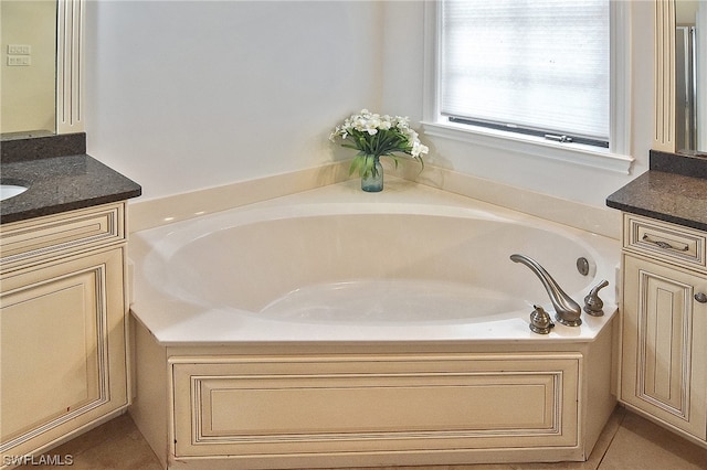 bathroom with vanity and a tub