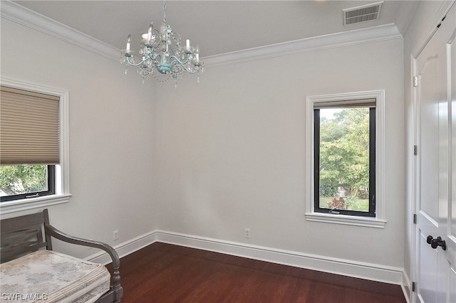 bedroom with crown molding, dark hardwood / wood-style floors, and a notable chandelier