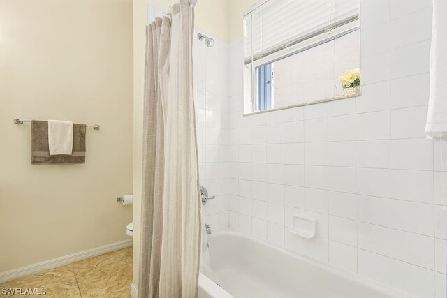 bathroom featuring shower / bath combo and toilet