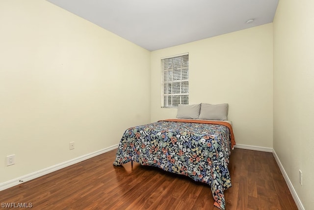 bedroom with hardwood / wood-style flooring