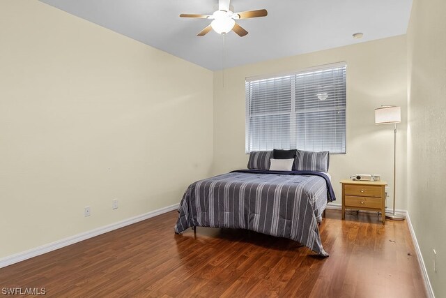 bedroom featuring ceiling fan and dark wood-type flooring