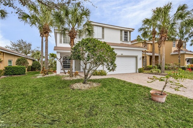 mediterranean / spanish-style home with a front yard and a garage