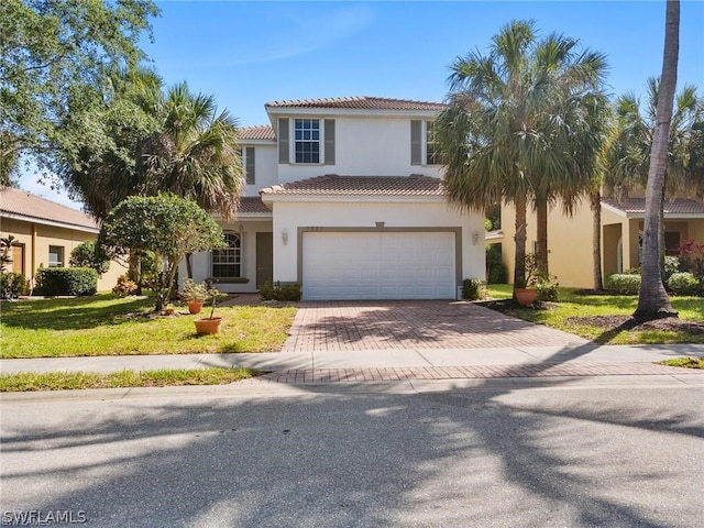 mediterranean / spanish-style home with a front lawn and a garage