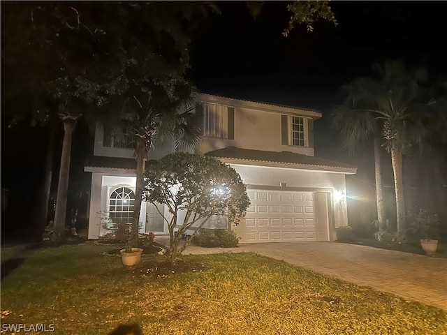 view of front facade featuring a yard and a garage