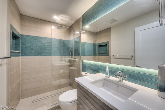 bathroom with backsplash, toilet, a shower with shower door, and large vanity