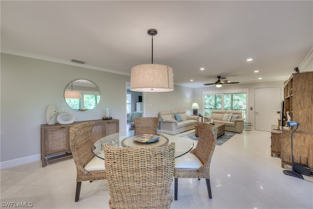 dining space with ornamental molding, ceiling fan, and light tile floors