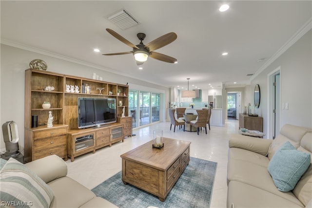 living room with crown molding, ceiling fan, and light tile flooring