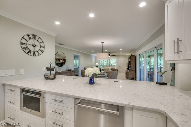 kitchen with pendant lighting, oven, and light stone counters