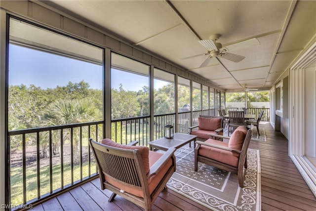 sunroom featuring ceiling fan