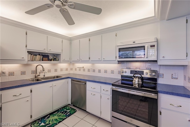 kitchen with ceiling fan, appliances with stainless steel finishes, white cabinets, backsplash, and sink