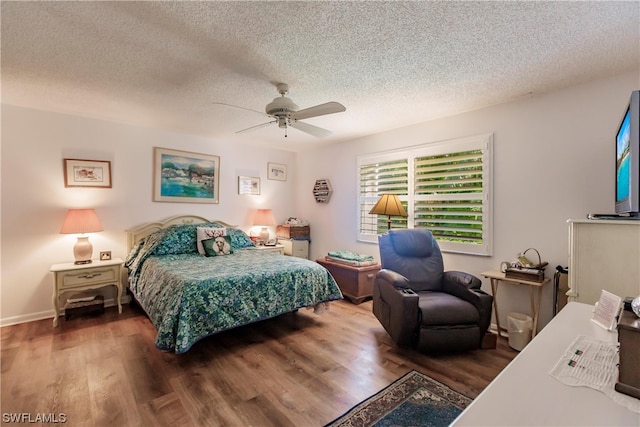 bedroom featuring ceiling fan, a textured ceiling, and dark hardwood / wood-style flooring