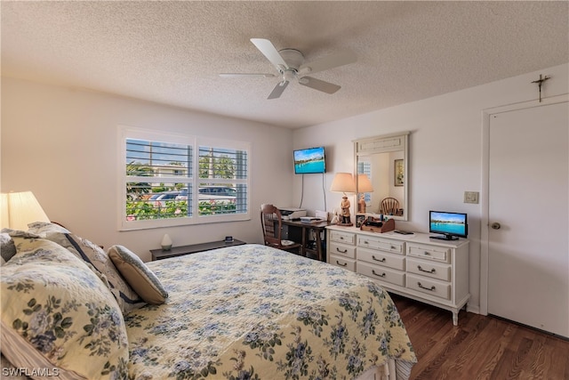 bedroom featuring dark hardwood / wood-style flooring, a textured ceiling, and ceiling fan