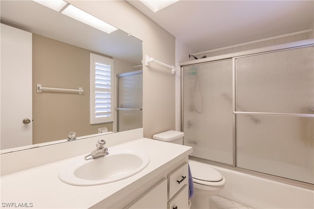 full bathroom featuring enclosed tub / shower combo, toilet, oversized vanity, and tile flooring