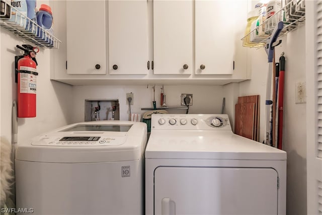 clothes washing area featuring washer hookup, electric dryer hookup, independent washer and dryer, and cabinets