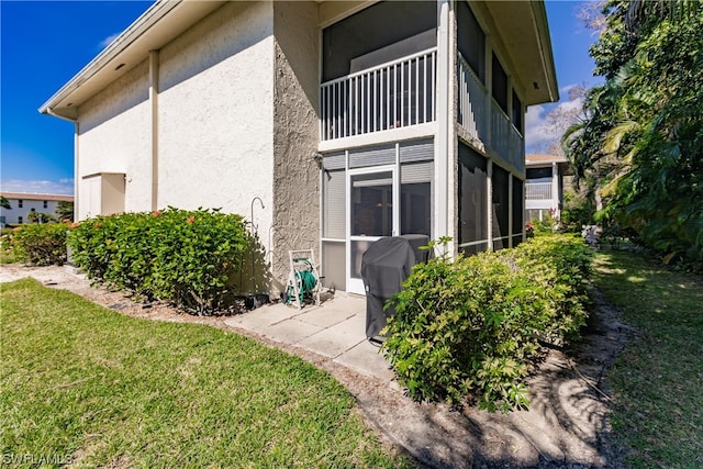 view of side of home featuring a yard