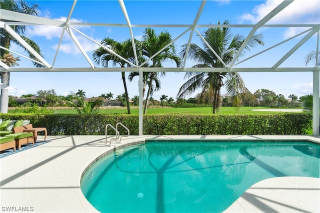 view of swimming pool featuring glass enclosure and a patio