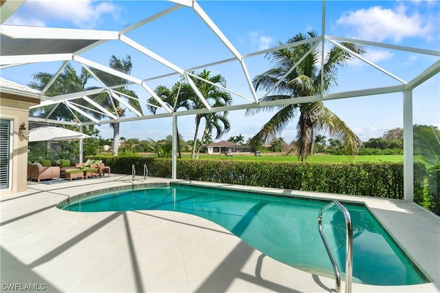 view of swimming pool with glass enclosure, outdoor lounge area, and a patio area