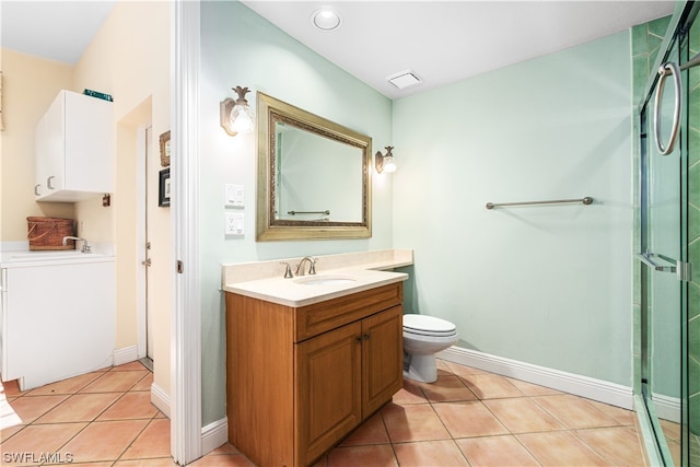 bathroom with a shower with door, toilet, vanity, and tile patterned flooring