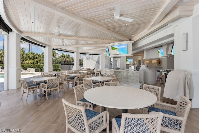 dining room with light wood-type flooring, ceiling fan, wood ceiling, and floor to ceiling windows