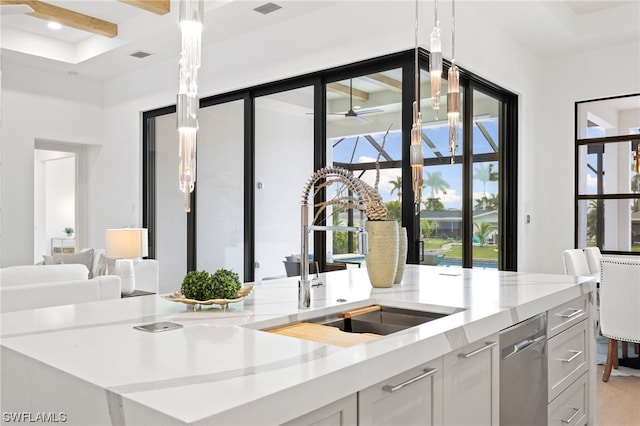 kitchen featuring ceiling fan, light hardwood / wood-style floors, dishwasher, sink, and pendant lighting