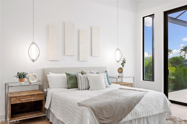 bedroom featuring hardwood / wood-style flooring and access to outside