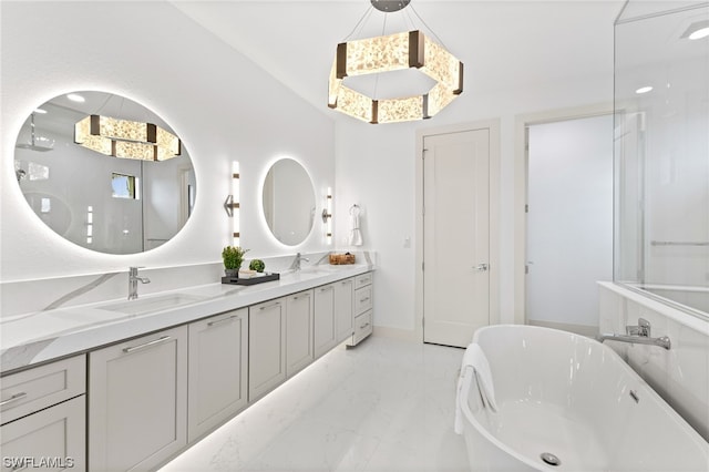 bathroom with dual sinks, oversized vanity, a tub, and tile floors