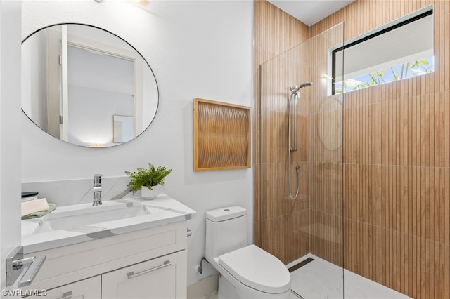 bathroom featuring vanity, an enclosed shower, and toilet