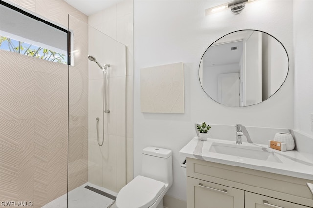 bathroom featuring a shower with door, oversized vanity, and toilet