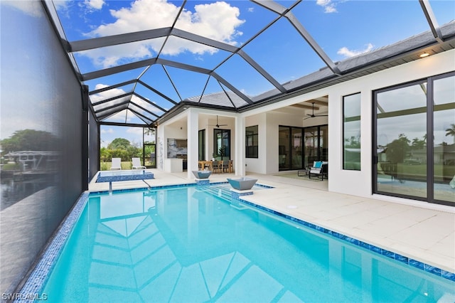 view of swimming pool featuring a patio area, ceiling fan, and glass enclosure