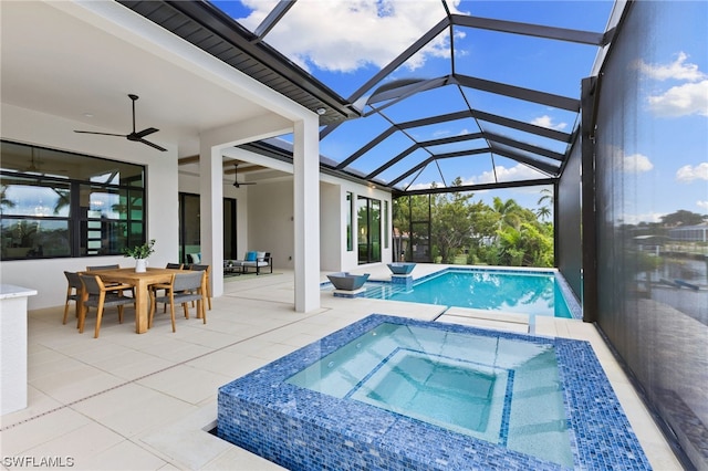 view of swimming pool with a patio, a lanai, an in ground hot tub, and ceiling fan