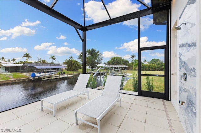 sunroom featuring a water view