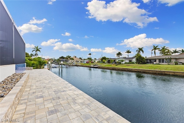 exterior space with a dock, a lawn, and a water view