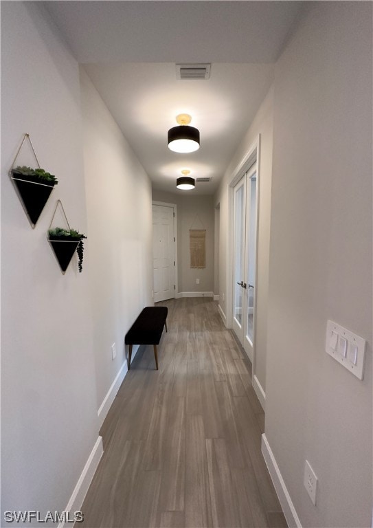 corridor featuring french doors and dark hardwood / wood-style floors