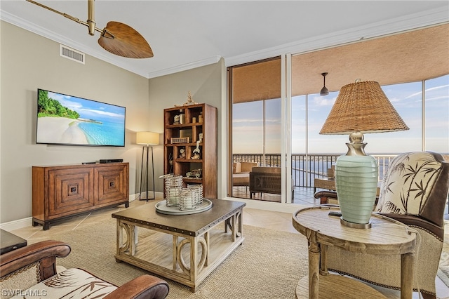 tiled living room with ornamental molding and ceiling fan