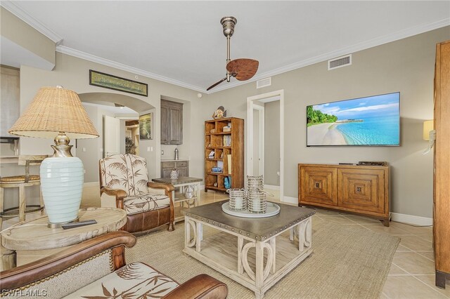 living room with crown molding and light tile flooring