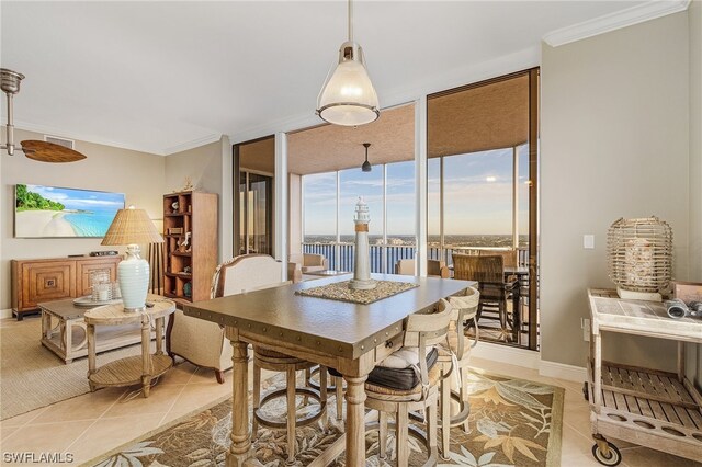 dining room with crown molding and light tile flooring