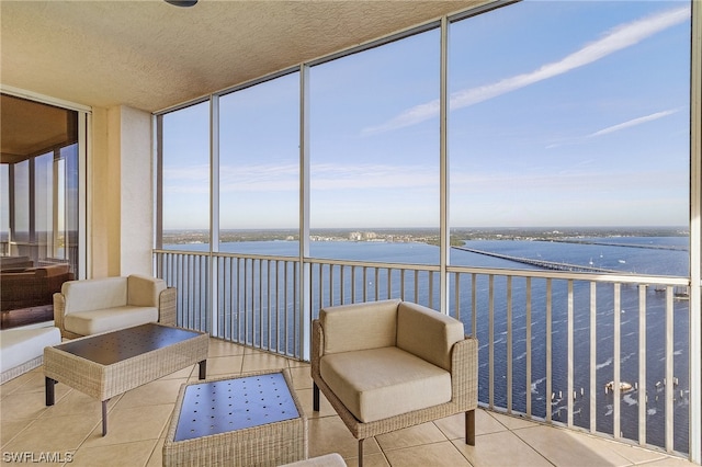 sunroom / solarium with a water view