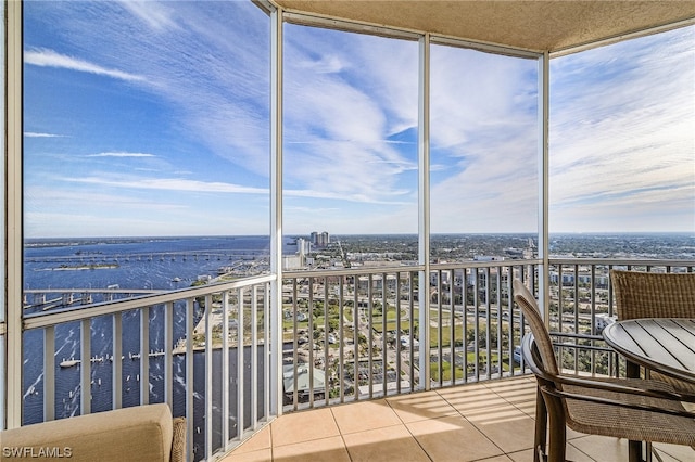 unfurnished sunroom featuring a water view