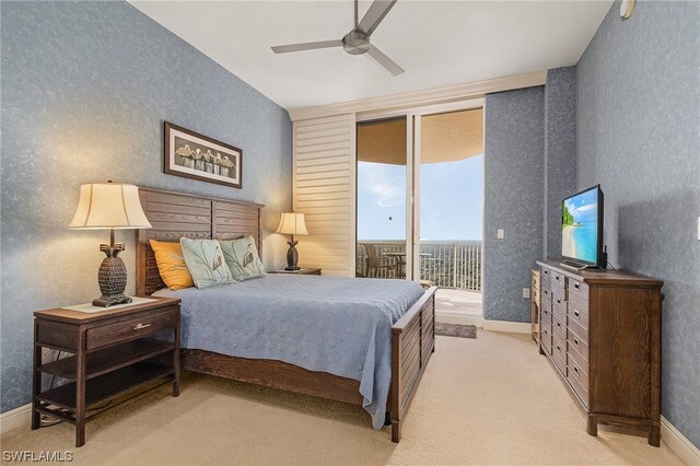 bedroom with light carpet, ceiling fan, and access to outside