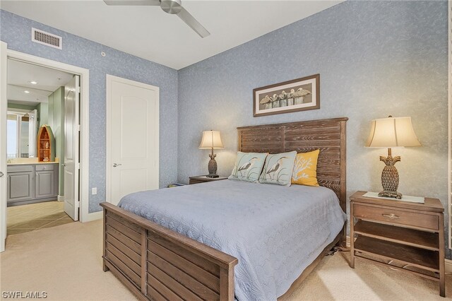 carpeted bedroom featuring connected bathroom and ceiling fan