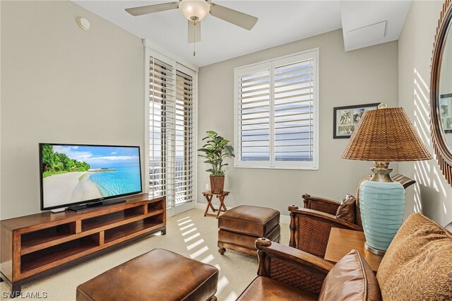 living room featuring ceiling fan and a wealth of natural light