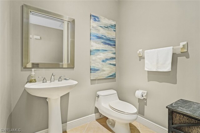 bathroom with toilet and tile floors