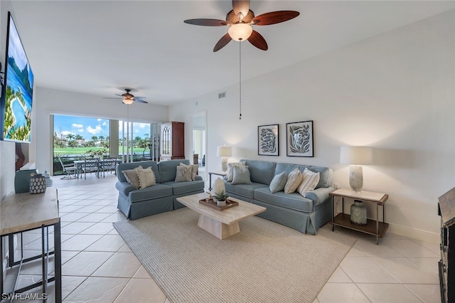 tiled living room with ceiling fan