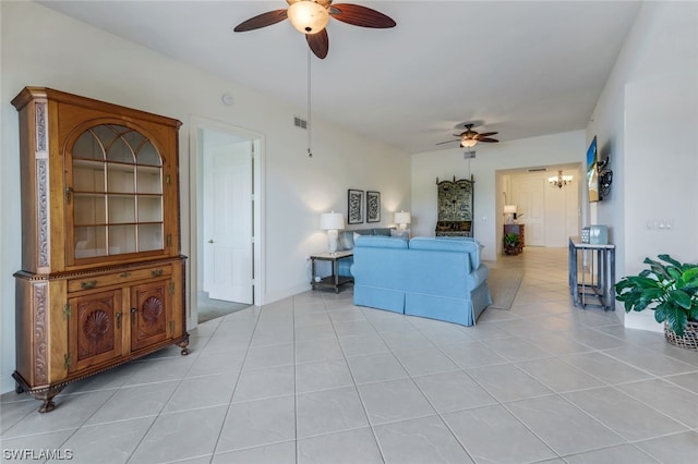 tiled living room with ceiling fan