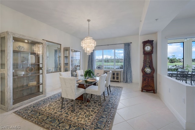 tiled dining space with a chandelier